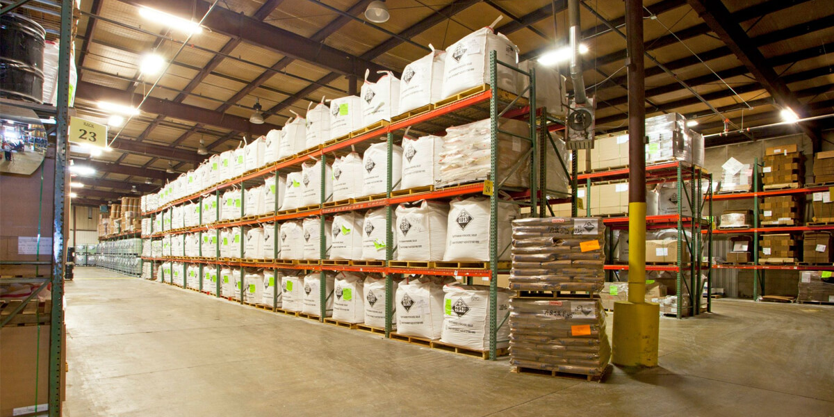Bulk chemicals packaged and shelved in a warehouse, ready for transport